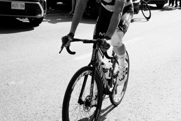 A cyclist with a bandage on their knee.